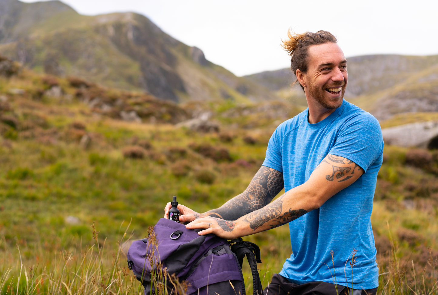 Image of hiker in the mountains with the Soulside natural sleep aid tincture, Sweet Slumber, in his backpack.