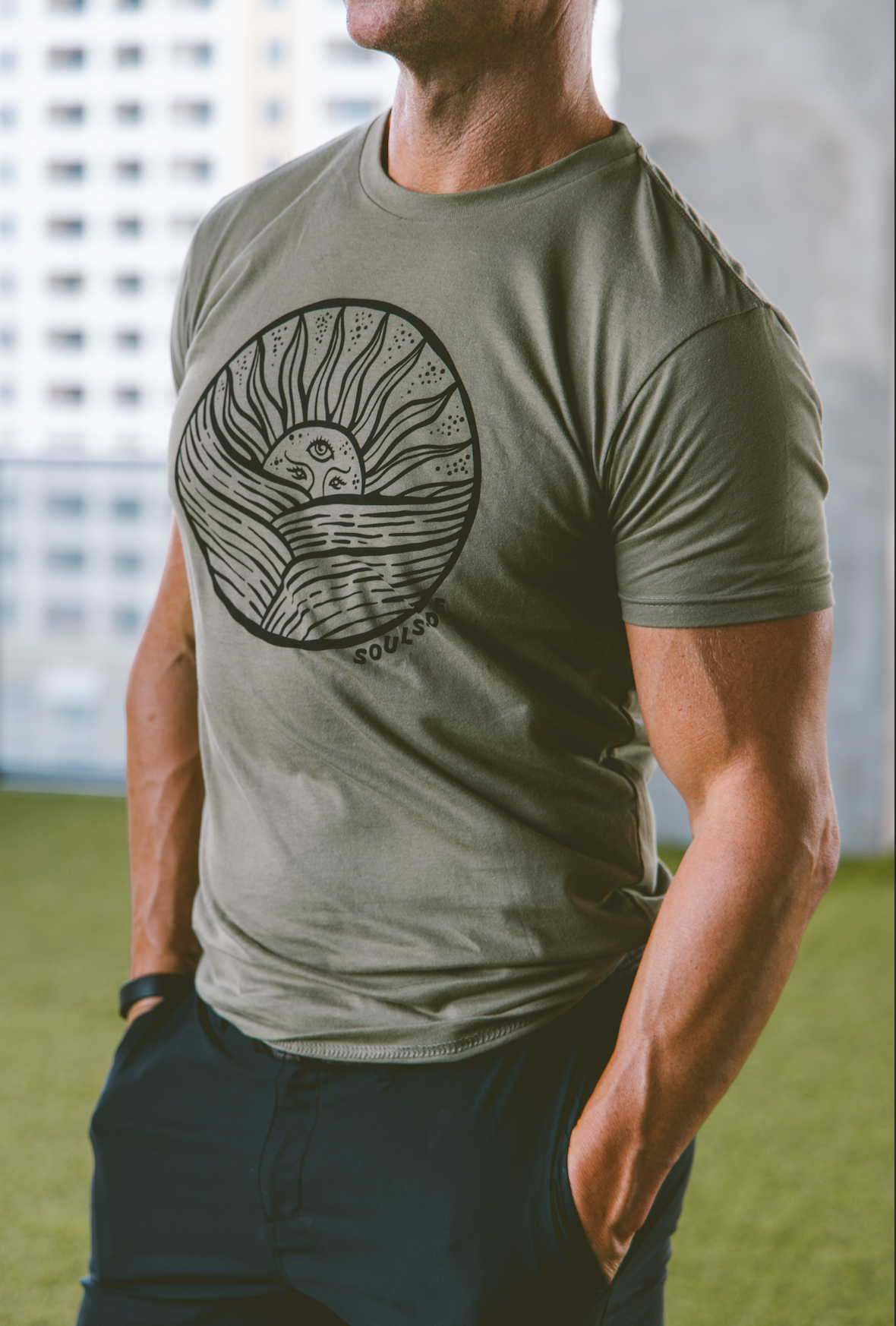 Image of athletic man wearing Soulside men's begin again t-shirt, a premium t-shirt made with original art depicting a hand drawn sun.